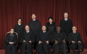 A group of people in black robes posing for a photo, featuring members of the Amazon Marketplace.