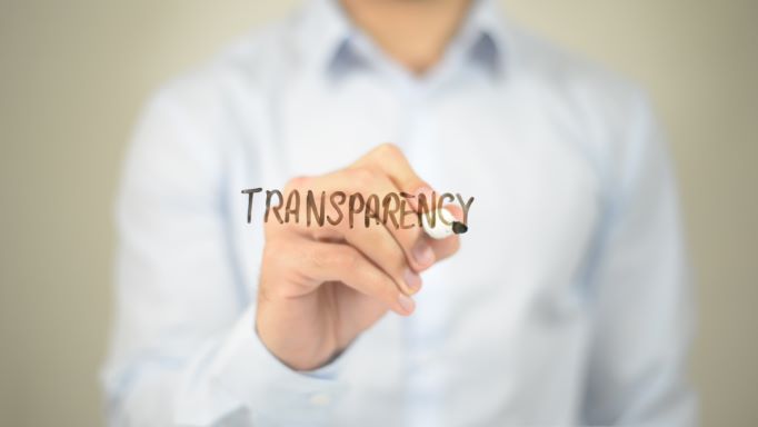 A man, possibly named "my amazon guy," is writing the word transparency on a piece of paper, highlighting his expertise in marketplace and marketing management.