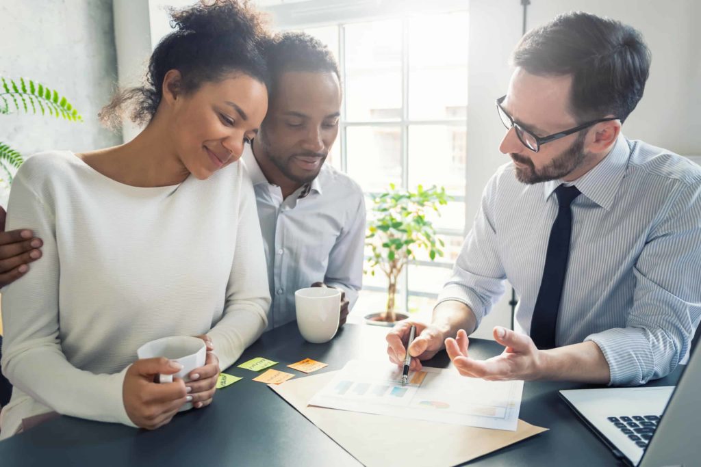 A group of people sitting around a table discussing marketing strategies for Amazon's account management.