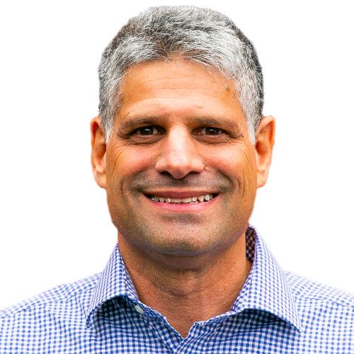 A smiling man in a blue shirt expertly handles seller central management for an online marketplace.