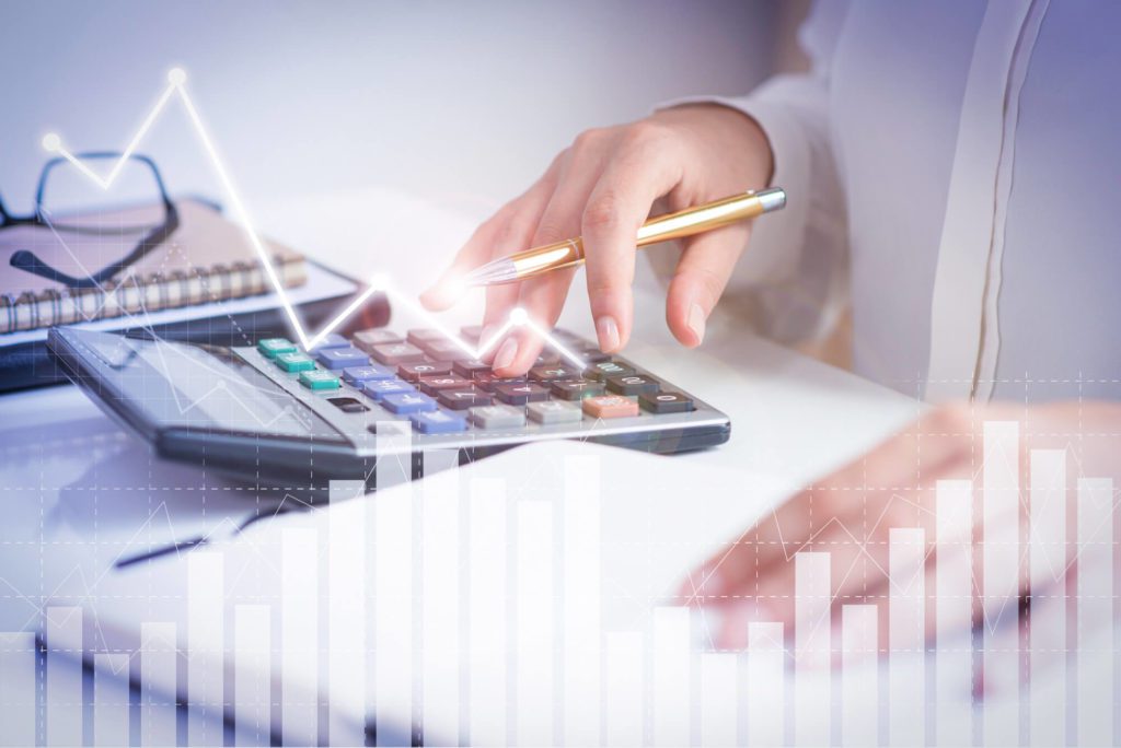 A woman in marketing management is using a calculator to calculate a graph for the marketplace.