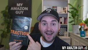 A man holding up a book titled "Traction" in a marketplace.