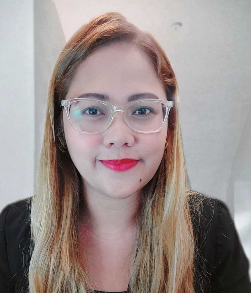 A woman in glasses is posing for a photo for Amazon.